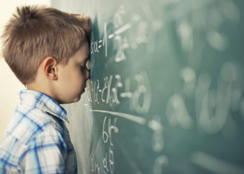 Little boy in math class overwhelmed by the math formula.