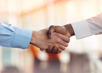 Handshake between african and a caucasian man.