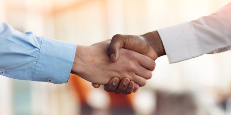 Handshake between african and a caucasian man.