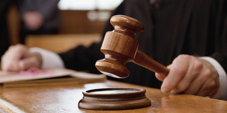 Judge holding gavel in courtroom