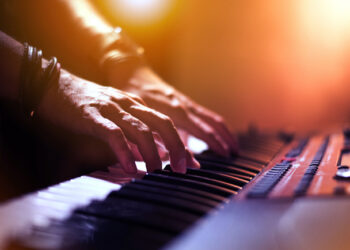 Image of Hands of keyboard player at the stage.