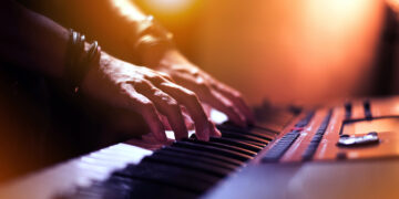 Image of Hands of keyboard player at the stage.